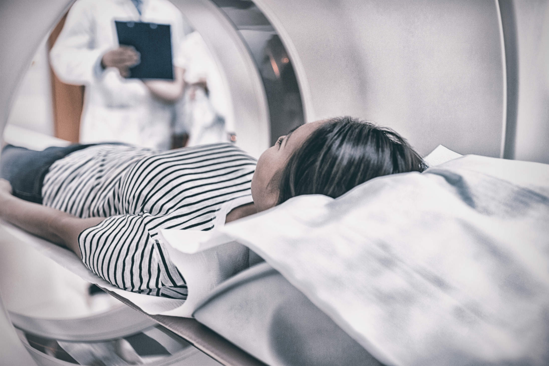 Female patient undergoing CT scan in hospital